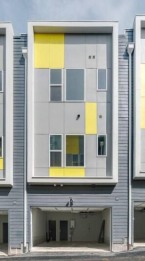 A modern building with a flat facade and multiple windows.
