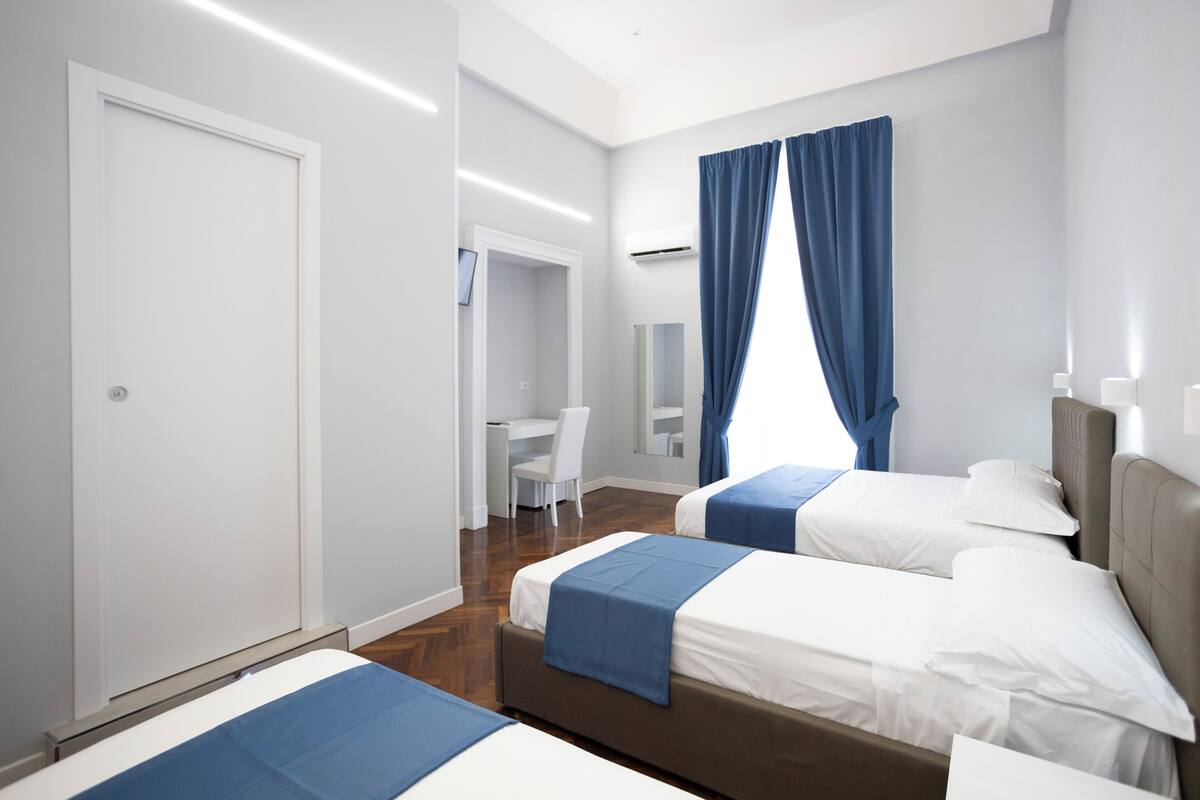Deluxe Quadruple Room | Premium bedding, down comforters, desk, laptop workspace