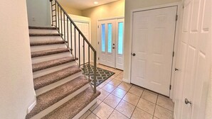 A staircase with carpeted steps and metal railings leading to a landing. - Long Lake North Periwinkle (Phillips)