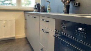 A modern kitchen with a built-in oven and a digital display showing 200.1. - 2 Bedroom Apartment in Magdeburg (Magdeburg)