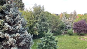 A grassy area with trees and a tennis court. - 2 Bedroom Apartment in Magdeburg (Magdeburg)