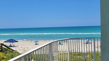 Enjoy the ocean views from this beachfront balcony with access to the sandy shore.