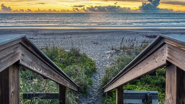 A wooden boardwalk leading to a beach with a sunset view. - Unbelievable View- No other unit has a view like this one. (Indialantic)
