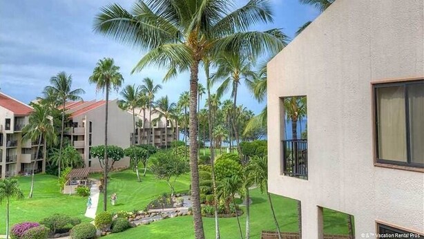 A resort with multiple buildings, palm trees, and well-maintained lawns. - Kamaole Sands #2-401 Beautifully Renovated Suite, Family Friendly, A/C! (Kihei)