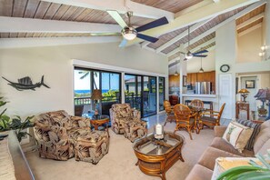 A spacious living area with a ceiling fan, wicker furniture, and a view to the outside. - Wailea Ekolu #306 Panoramic Ocean Views on Wailea Golf Course, Wifi, A/C (Wailea)
