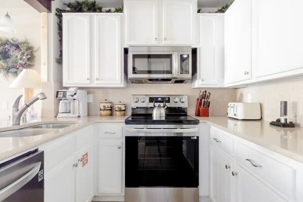 Enjoy cooking in this fully equipped kitchen with a microwave, oven, and coffee maker.