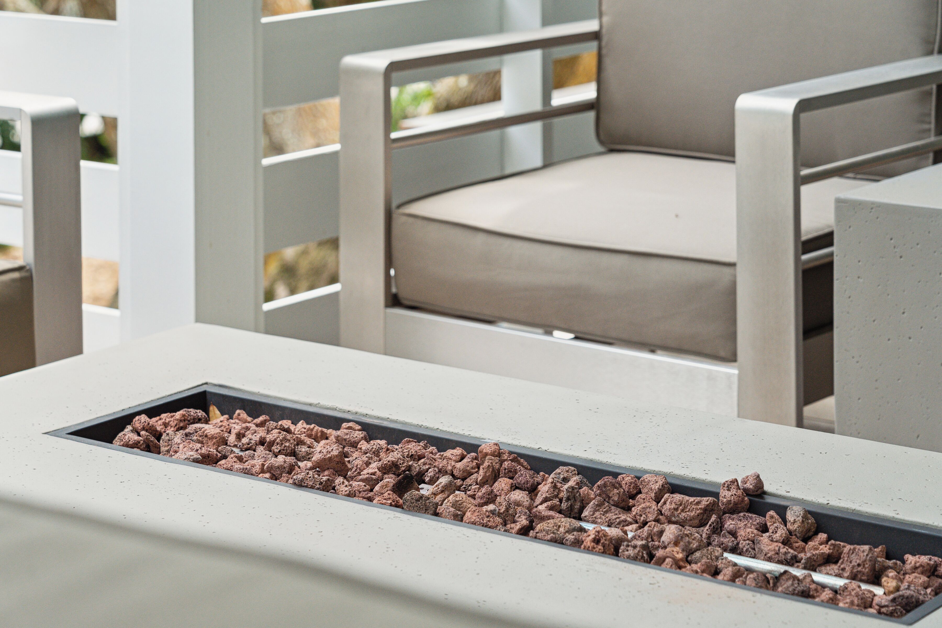 A modern outdoor seating area with a built-in fire feature.