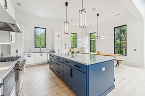 Fridge, dishwasher, coffee/tea maker, cookware/dishes/utensils