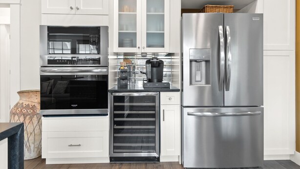 A modern kitchen with stainless steel appliances, including a refrigerator, oven, and microwave.
