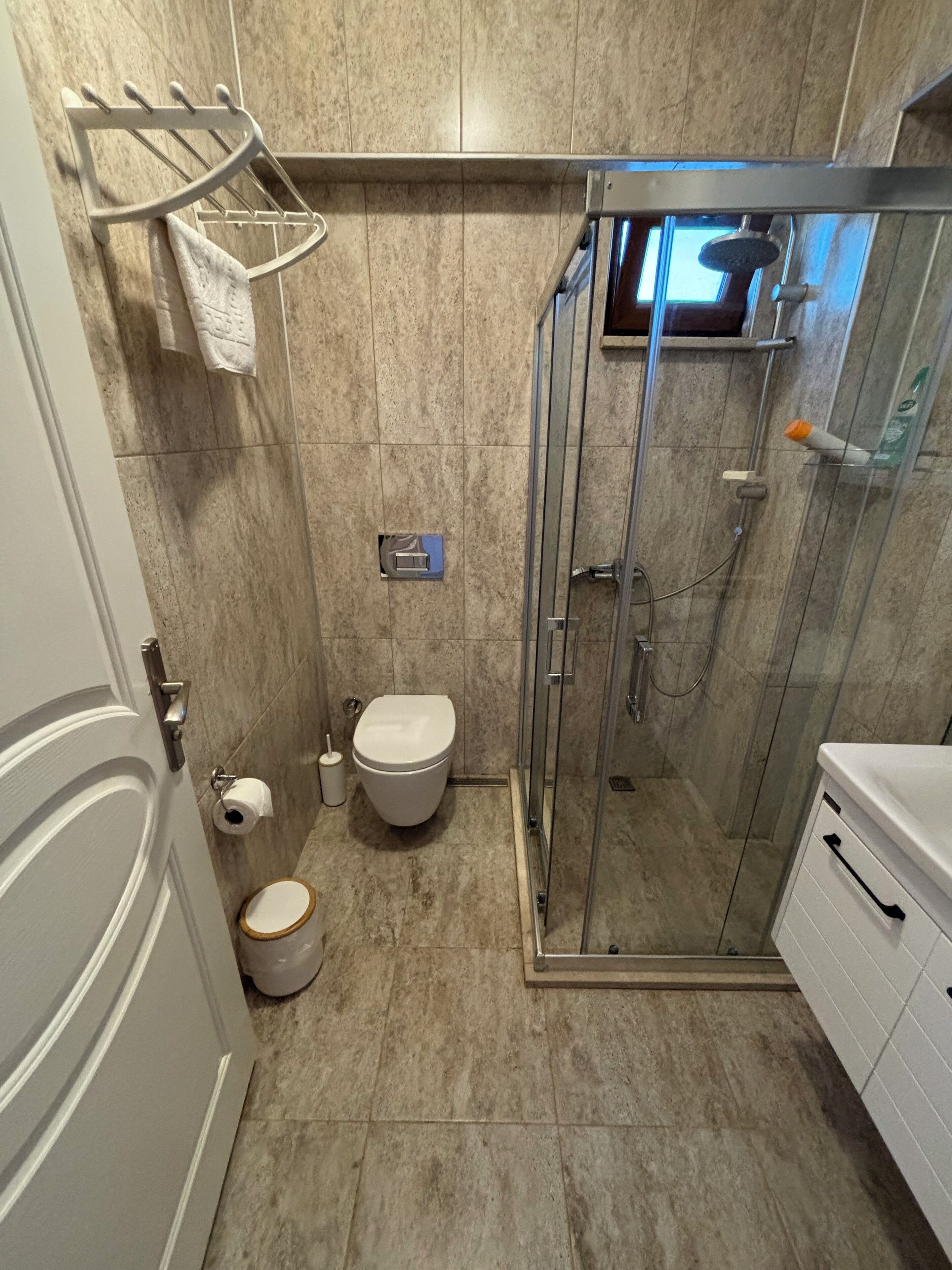 A bathroom with a toilet, bidet, and shower stall.