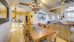 A spacious dining area with a wooden table and chairs, a chandelier, and a ceiling fan. - Game Room + Patios: Home 2 Mi to Dtwn Flagstaff (Flagstaff)