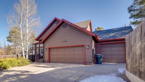 A two-car garage attached to a house with a sloped roof and a red trim. - Game Room + Patios: Home 2 Mi to Dtwn Flagstaff (Flagstaff)