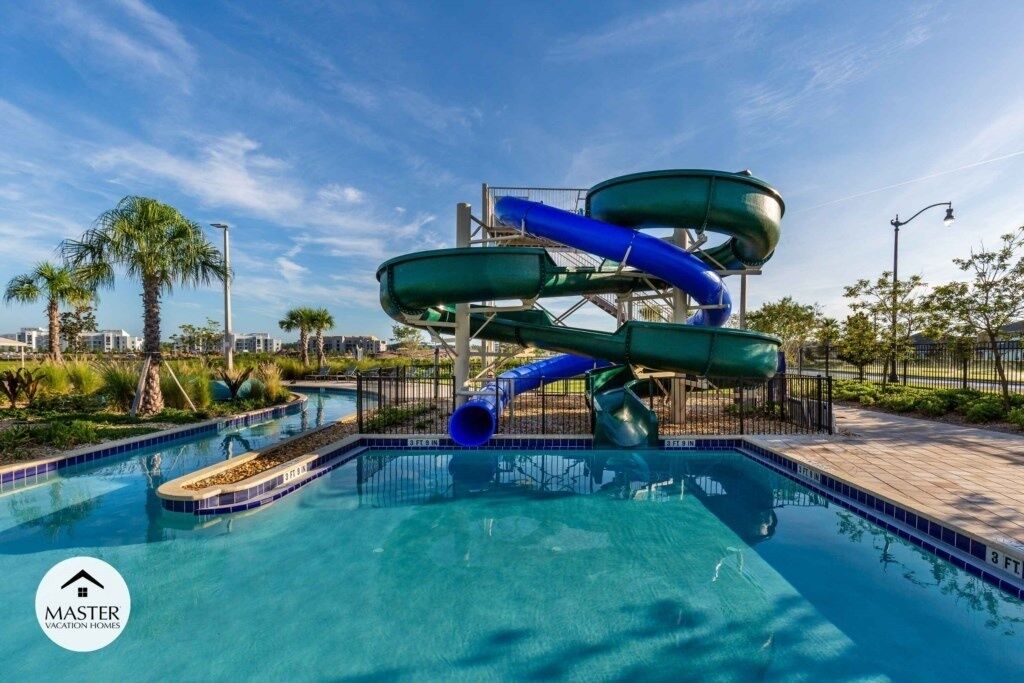 A swimming pool with a water slide structure.