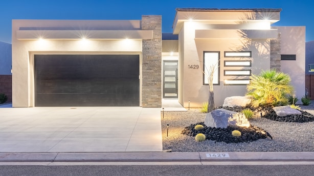 A modern house with a garage, number 1429, and a landscaped front yard with rocks and cacti. - Desert Dreaming 2 Bedroom Home by RedAwning (Washington)