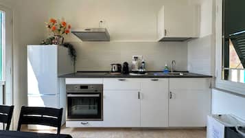 Exclusive Apartment | Private kitchen | Full-size fridge, microwave, oven, stovetop