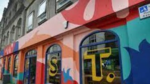 A colorful storefront with large windows and a sign that reads "Coffee." - Sea Haven  Stylish Beach Oasis - Pass the Keys (Hastings)