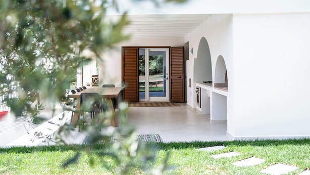 A modern house with a patio, a dining area, and a kitchen.