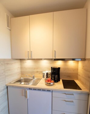 Fridge, coffee/tea maker, toaster, cookware/dishes/utensils