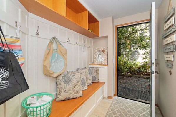 Enter a serene space with a comfortable bench and convenient storage.
