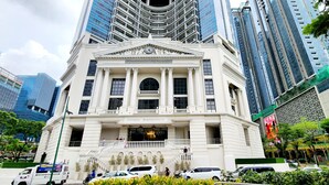 A building with a classical architectural style, featuring a central entrance with columns and a clock.