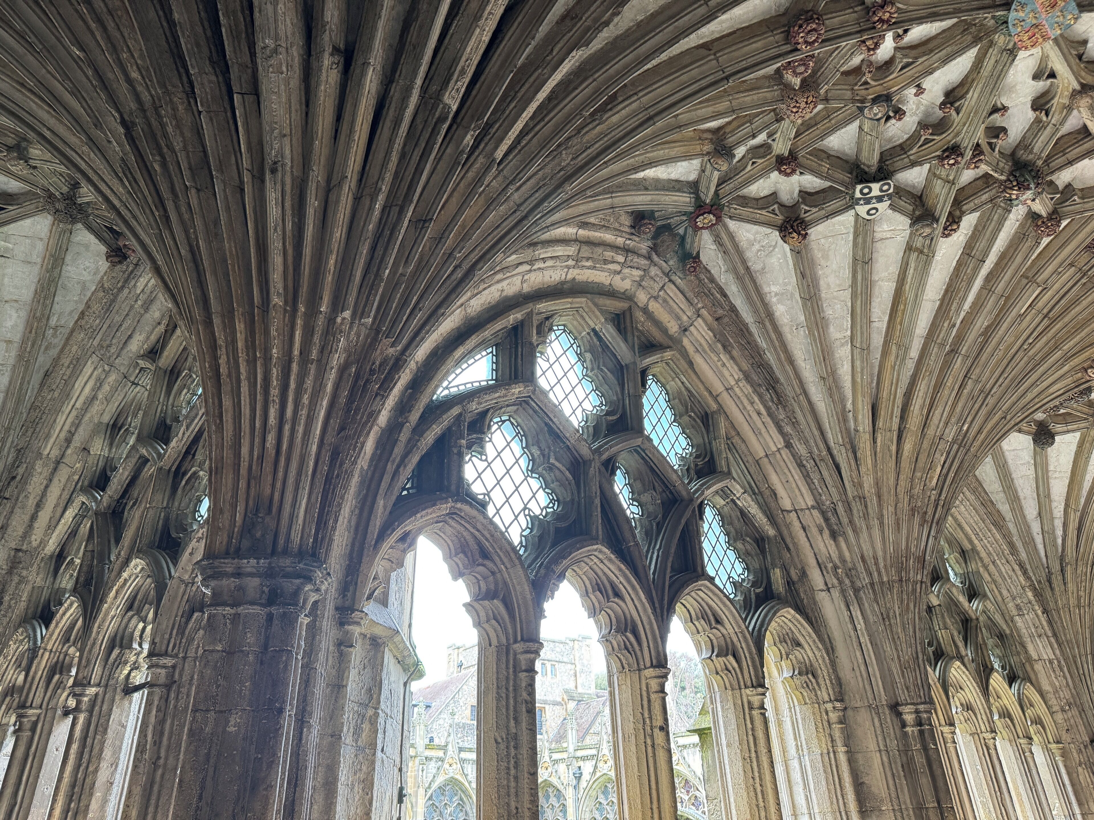 A cathedral interior with high vaulted ceilings and large stained glass windows.