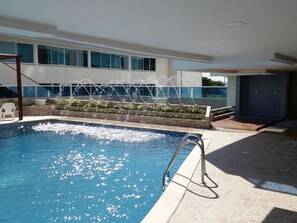 An indoor swimming pool with a clear view of the surrounding building, a water fountain feature, and a tiled floor. - Studio Apartment E11c Near The Sea With Pool (Cartagena)