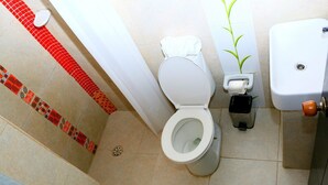 A bathroom with a toilet, a bidet, and a sink.