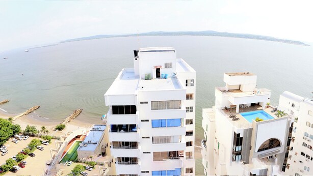 A high-rise hotel with multiple balconies overlooking a beach and the sea. - Apartment 1c19 Close To The Sea With Pool (Cartagena)