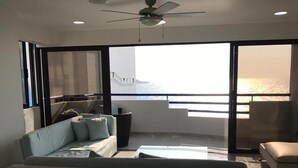 A modern living room with a sofa, a coffee table, and a balcony with a view of the sea. - 3mr8 Duplex Apartment Close To The Sea With Pool (Cartagena)