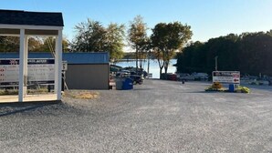 A small building with a signboard advertising fishing services. - Blue Oasis (Marion)