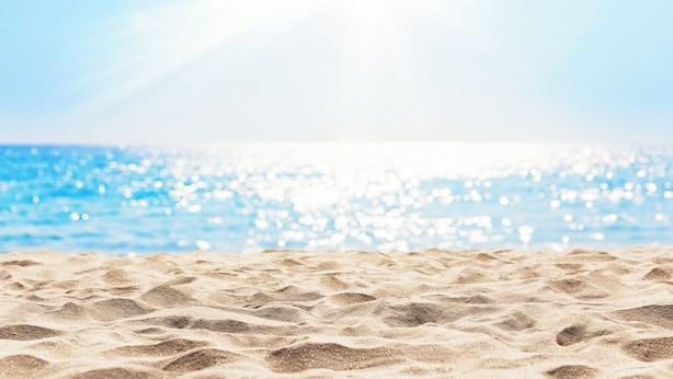 A beach with sand and water.