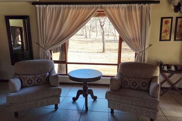 Luxury Double or Twin Room | Living area | TV