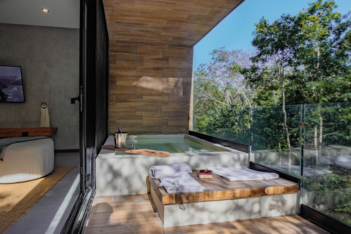 A modern room with a glass balcony, a wooden bench, and a bathtub.