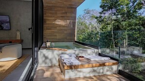 A modern room with a glass balcony, a wooden bench, and a bathtub. - Xambé  (Tulum)