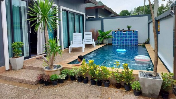 A modern house with a swimming pool, potted plants, and a covered patio area. - Luxury Private Pool Villa- Ao Nang Krabi  (Tambon Ao Nang)