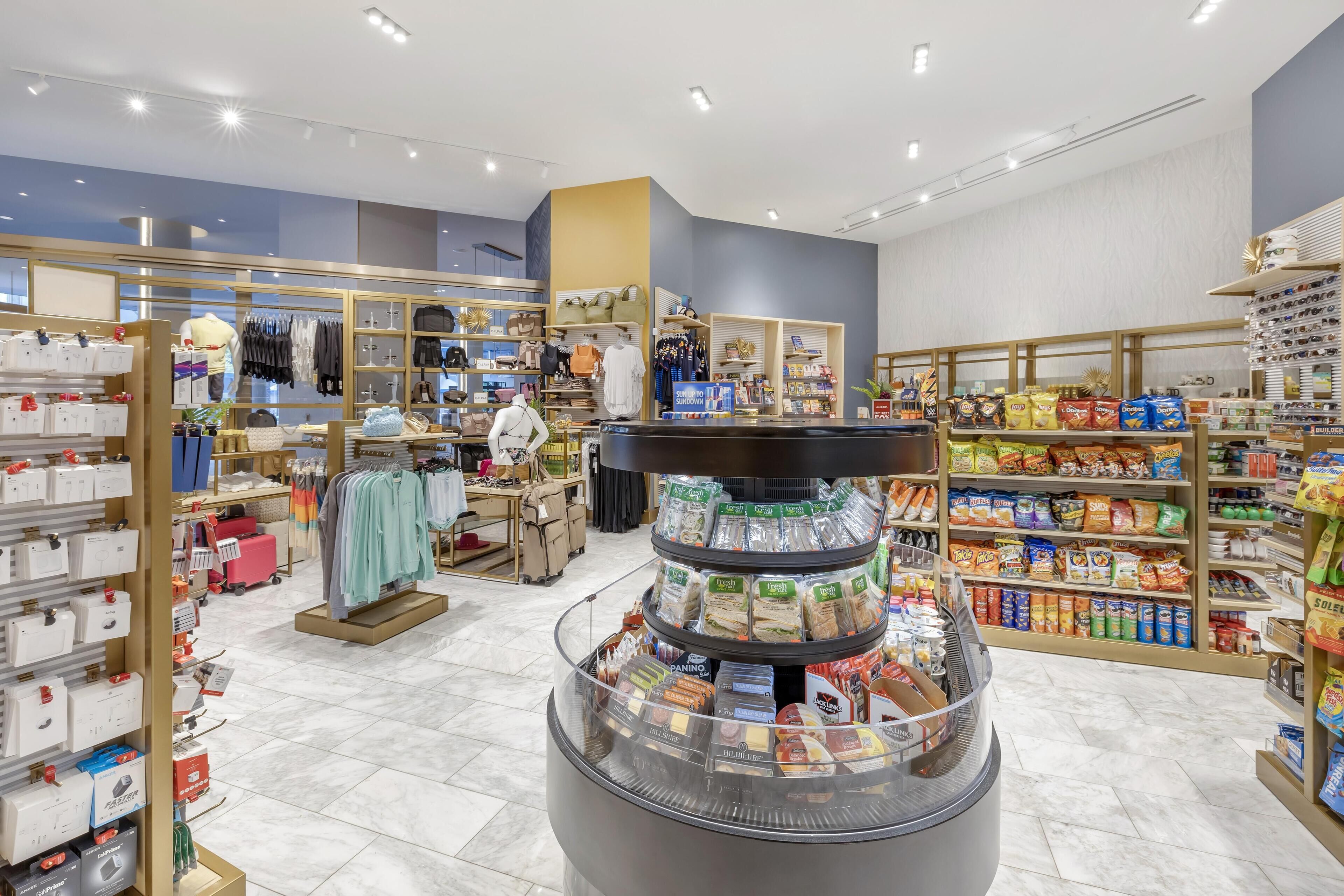A well-lit store with various sections including clothing, shoes, and snacks.