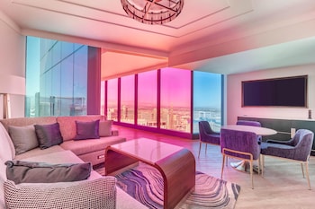 A high-rise building with a glass balcony offering a city view. at Hilton Club Elara Las Vegas