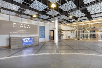 The entrance to the Elara Hilton Club with a glass facade and a modern design. at Hilton Club Elara Las Vegas