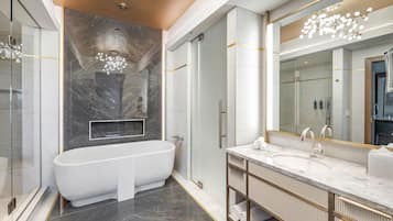 A modern bathroom with a freestanding bathtub, a large mirror, and a vanity with a sink.