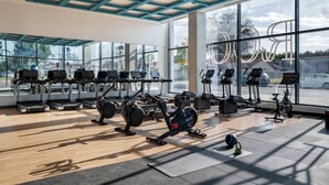 A gym with treadmills, stationary bikes, and weight machines. - Hilton Buena Park Anaheim (Buena Park)