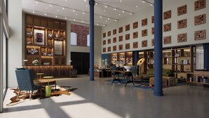 A spacious lobby with a reception desk, seating area, and a wall adorned with wooden geometric art pieces. - The Untitled Nashville Hotel, Tapestry Collection by Hilton (Nashville)