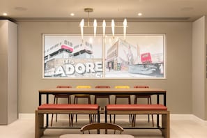 A conference room with a long table, multiple chairs, and two large framed artworks on the wall. - Hampton By Hilton London Old Street (London)