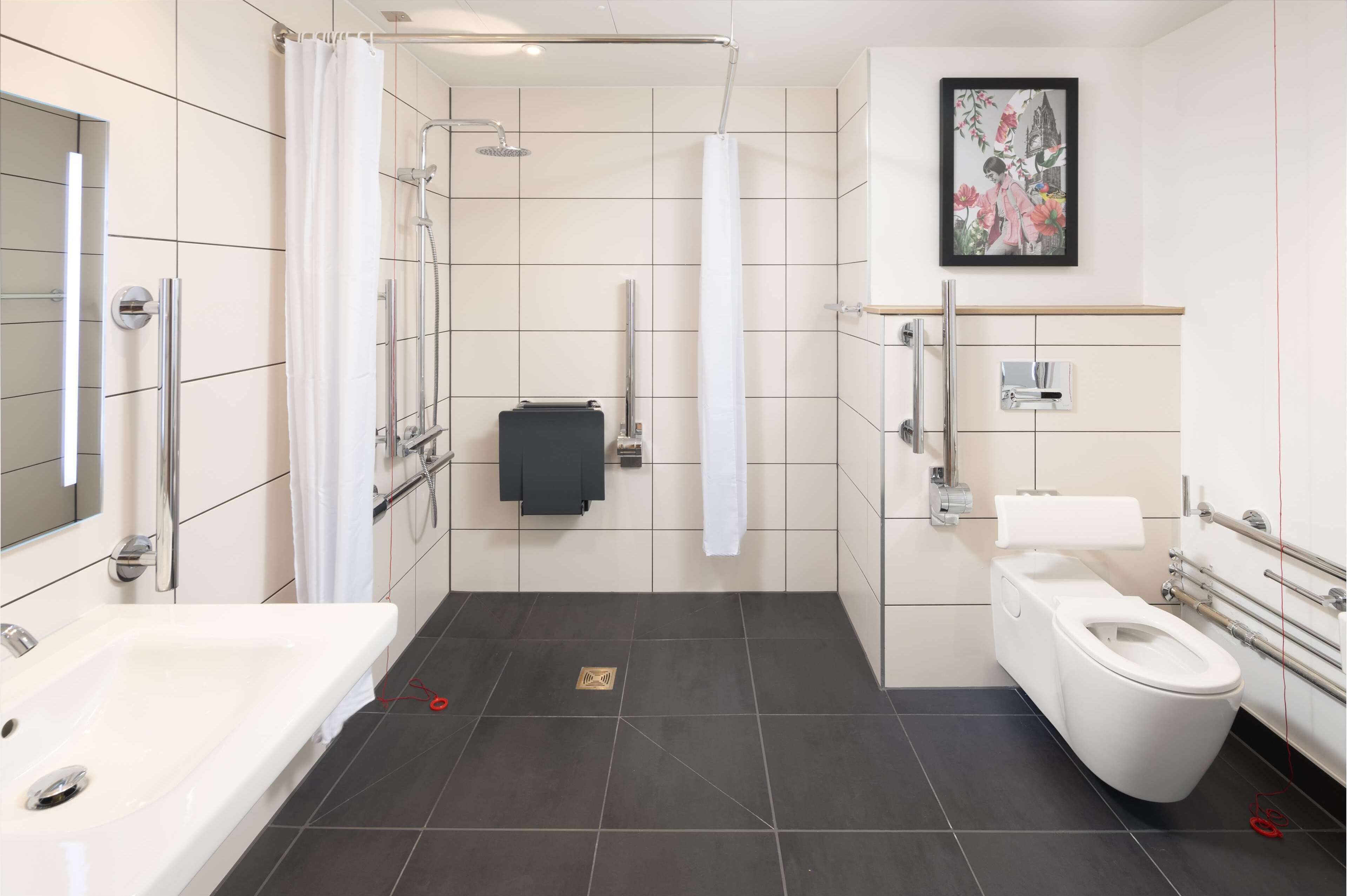 A modern bathroom with a bathtub, toilet, and shower.