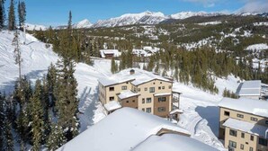 A snow-covered mountain town with buildings and trees.