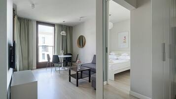 Deluxe Apartment | Living area | 40-inch flat-screen TV with cable channels