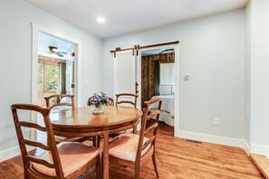 Enjoy meals in this cozy dining area with a round table and comfortable chairs.