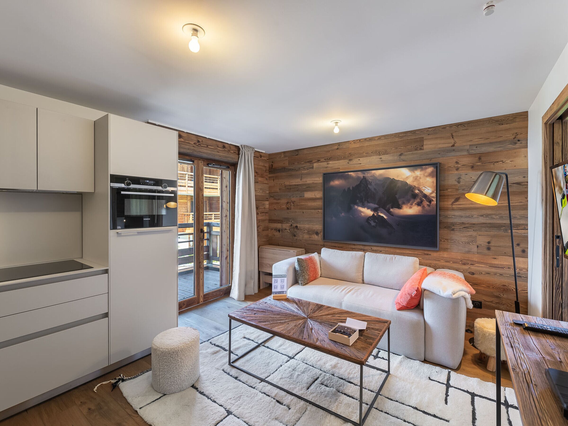 A modern living room with a sofa, coffee table, and a painting on the wall.