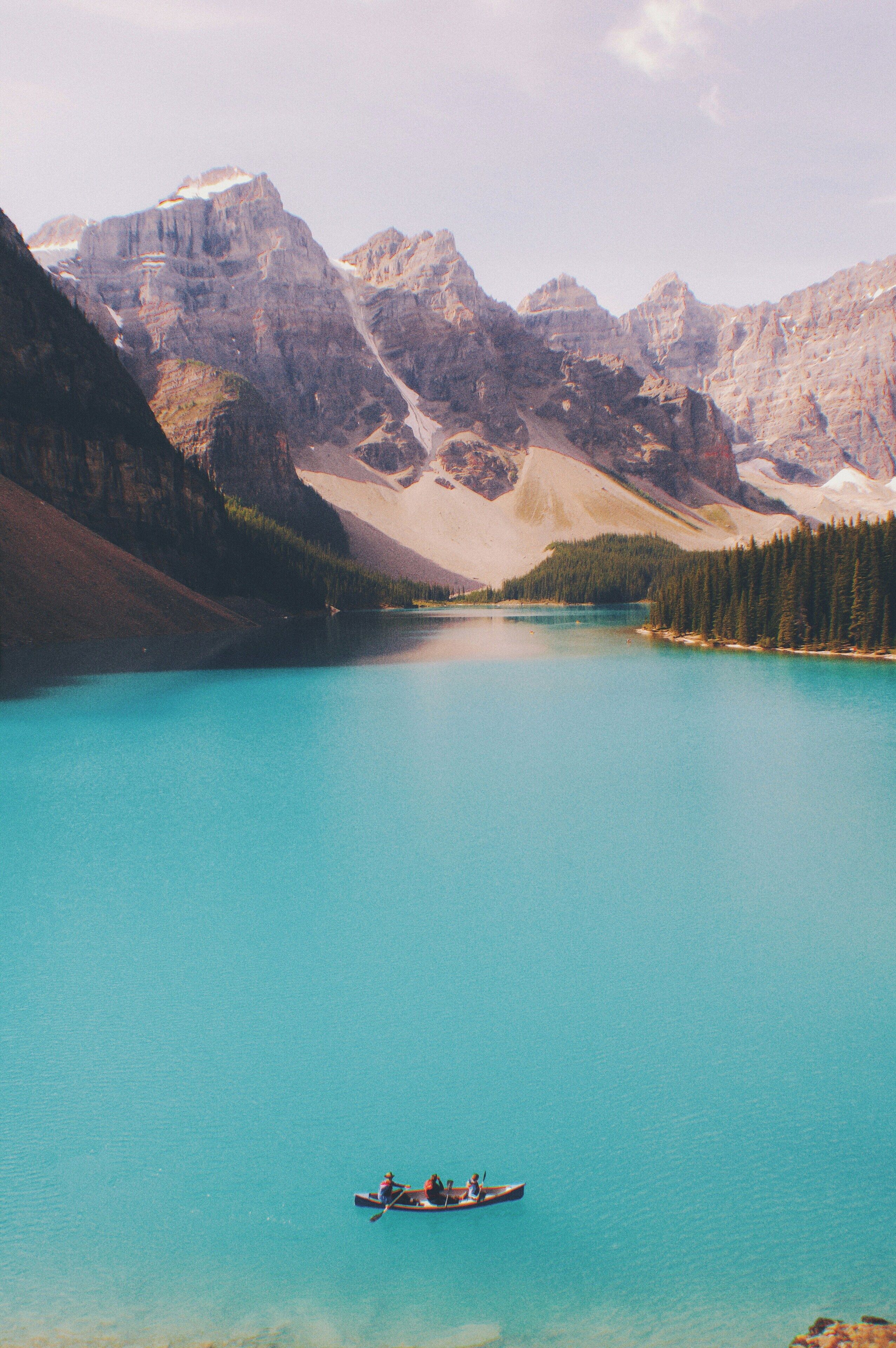 A calm lake surrounded by mountains.