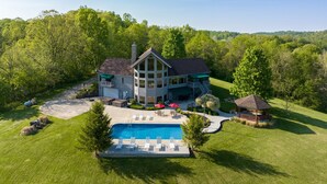 A large house with a swimming pool, a covered patio, and a guest house. - Among the Trees - The Lodge (Logan)