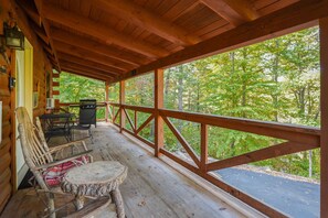 A wooden deck with a railing, a table, and chairs. - Sandstone Oasis | Hocking Hills, Couples, Hot Tub (Logan)